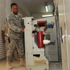 Engineer operating the handcart chassis of a 2000A indoor withdrawable vacuum circuit breaker in switchgear
